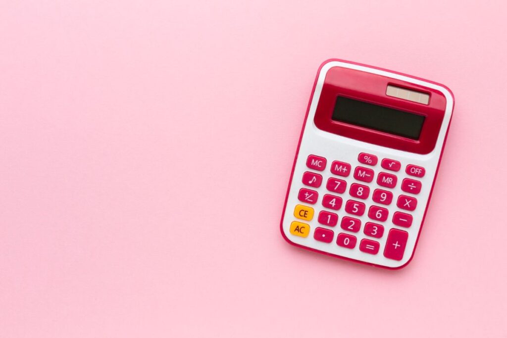 top-view-calculator-pink-background